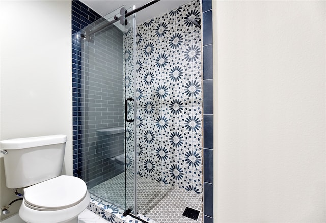 bathroom with an enclosed shower and toilet