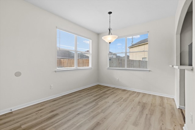 unfurnished dining area with light wood-type flooring