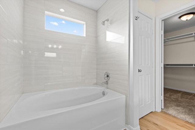 bathroom with wood-type flooring and tiled shower / bath combo