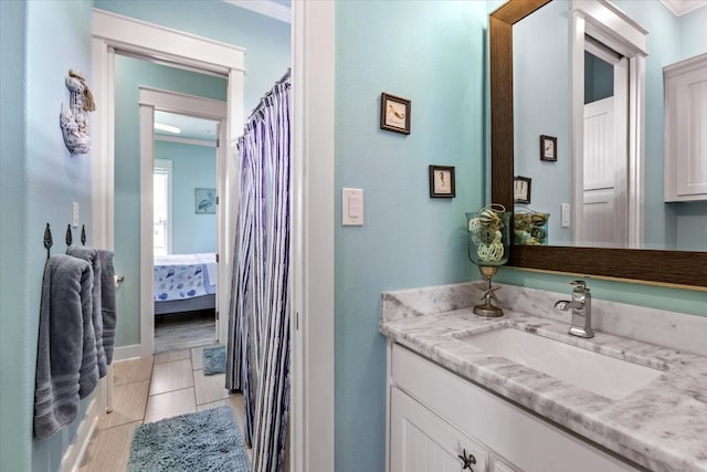 bathroom with ornamental molding, tile patterned flooring, and vanity