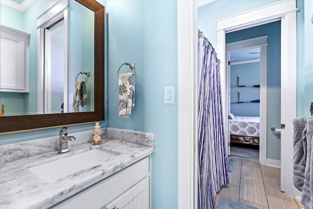 bathroom featuring vanity and ornamental molding