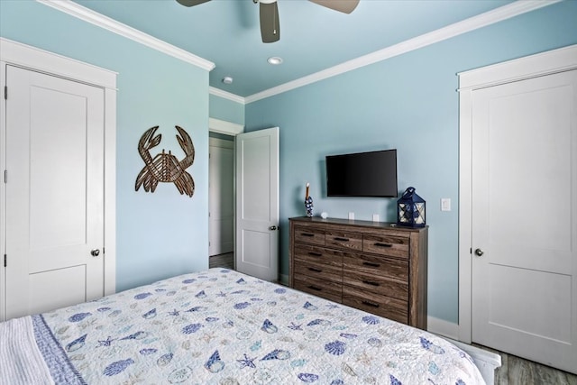 bedroom with crown molding, ceiling fan, and hardwood / wood-style flooring