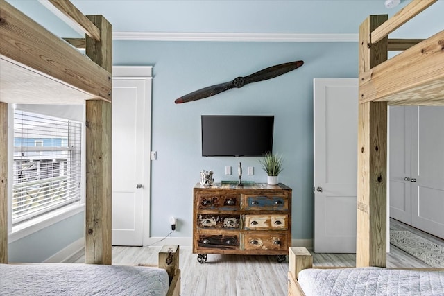 bedroom featuring ornamental molding, ceiling fan, and hardwood / wood-style flooring