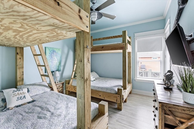 bedroom with ceiling fan, crown molding, and light hardwood / wood-style floors