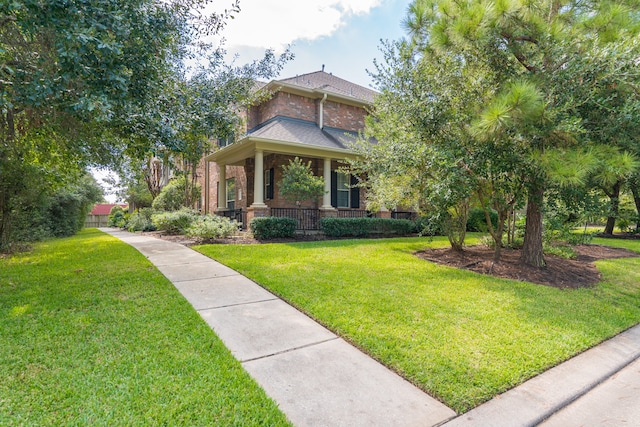 view of front facade with a front lawn and a porch