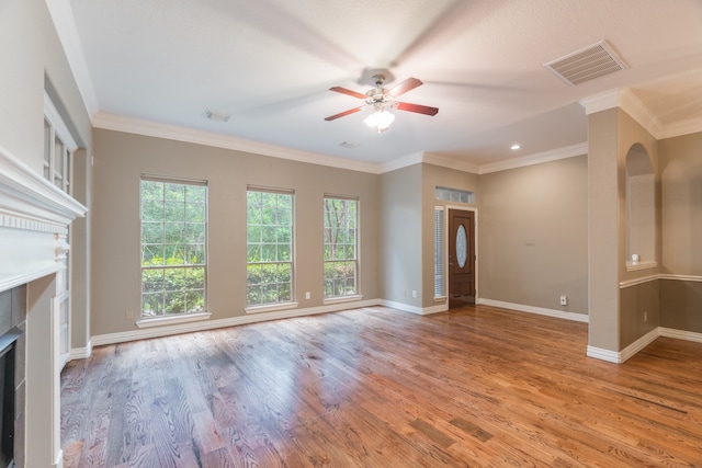 unfurnished living room featuring ceiling fan, light wood-type flooring, and crown molding