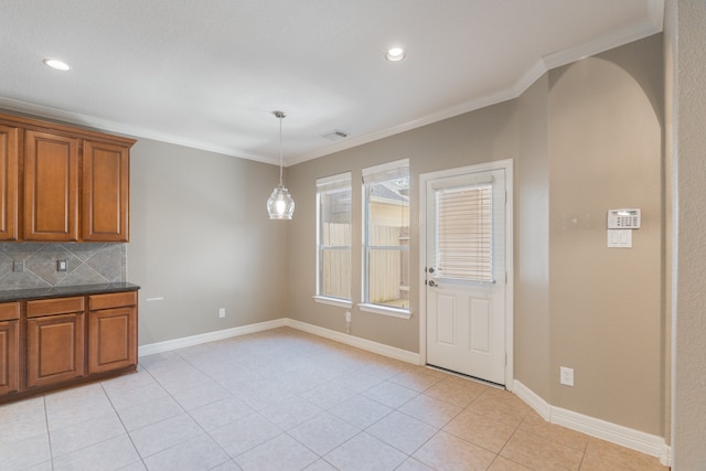 kitchen featuring hanging light fixtures, decorative backsplash, ornamental molding, and light tile patterned floors