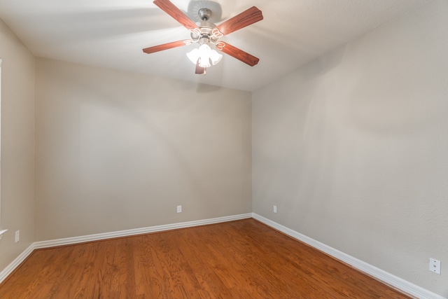 empty room with ceiling fan and hardwood / wood-style flooring