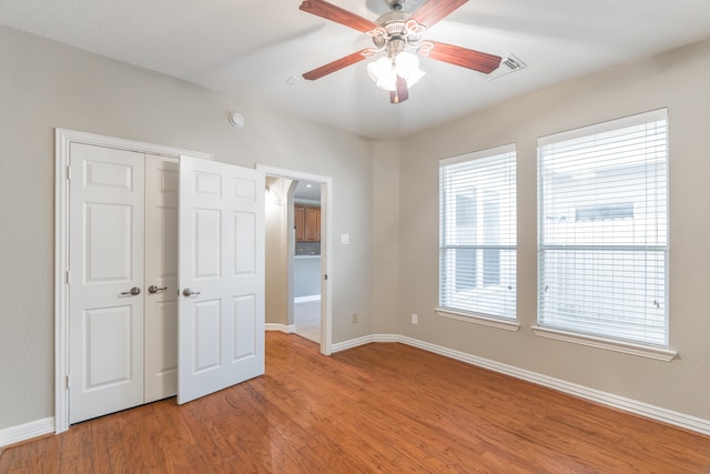 unfurnished bedroom featuring ceiling fan and hardwood / wood-style flooring