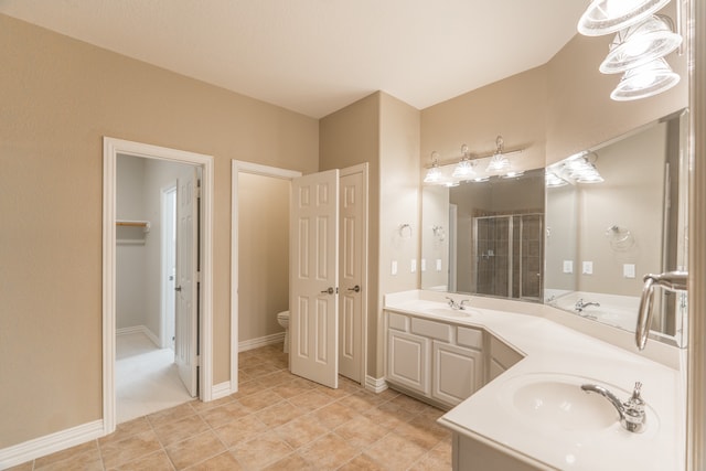 bathroom featuring tile patterned flooring, an enclosed shower, vanity, and toilet