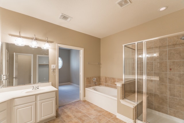 bathroom featuring a textured ceiling, vanity, separate shower and tub, and tile patterned floors