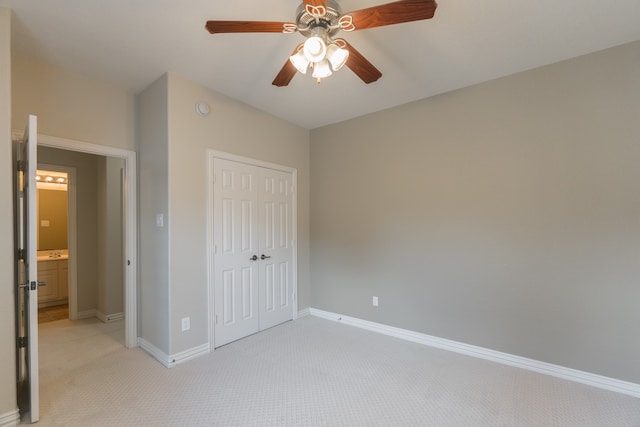 unfurnished bedroom featuring light carpet, ceiling fan, and a closet