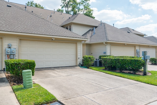 view of front facade featuring central AC and a garage