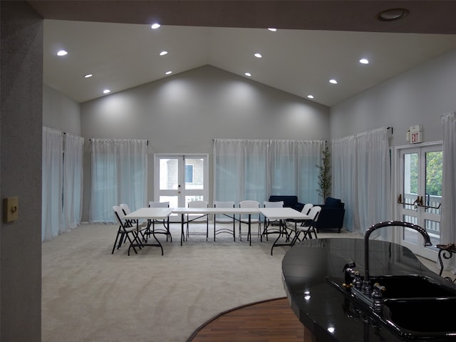 dining room featuring french doors, high vaulted ceiling, and carpet