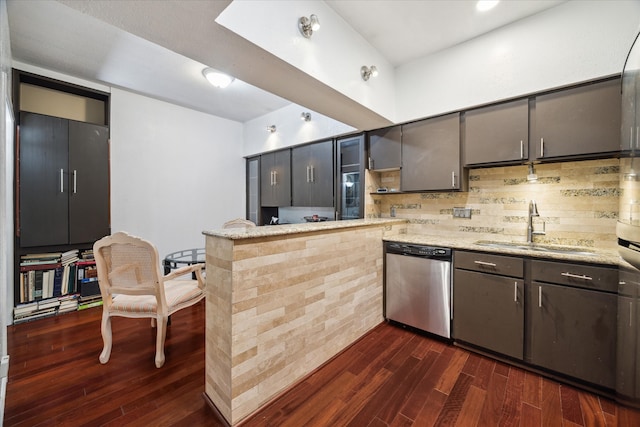 kitchen with dishwasher, kitchen peninsula, sink, dark hardwood / wood-style flooring, and tasteful backsplash