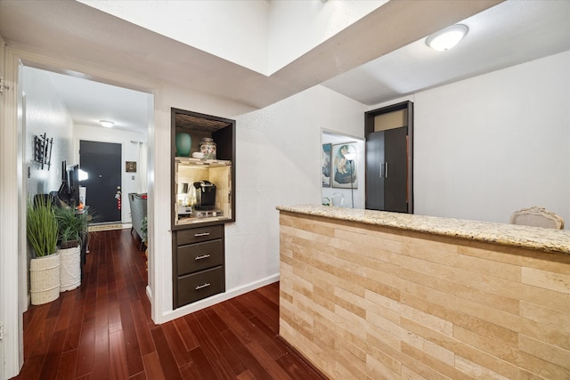 bar featuring dark hardwood / wood-style flooring