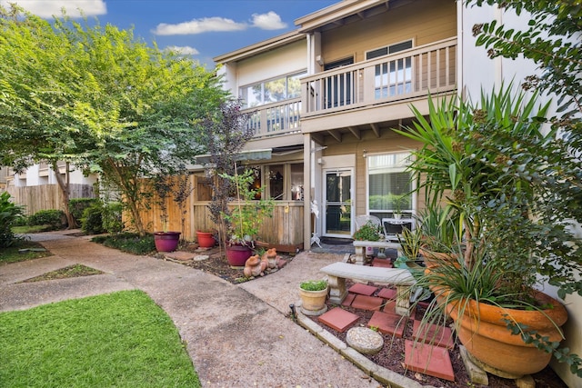 back of property featuring a balcony