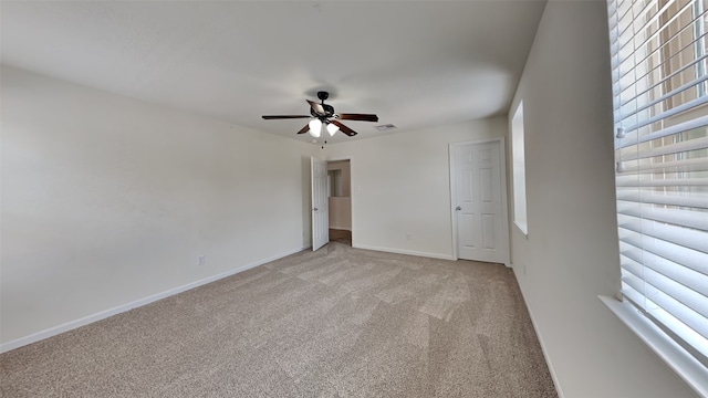 carpeted empty room featuring ceiling fan