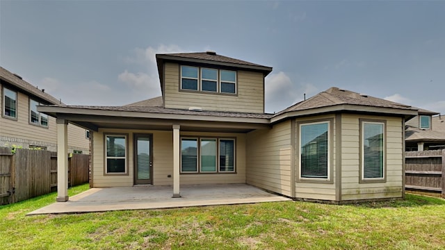 rear view of property featuring a patio and a yard