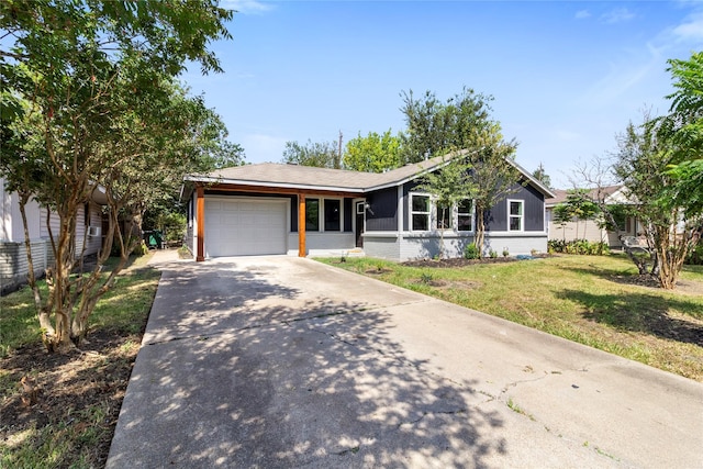 ranch-style house featuring a front lawn and a garage