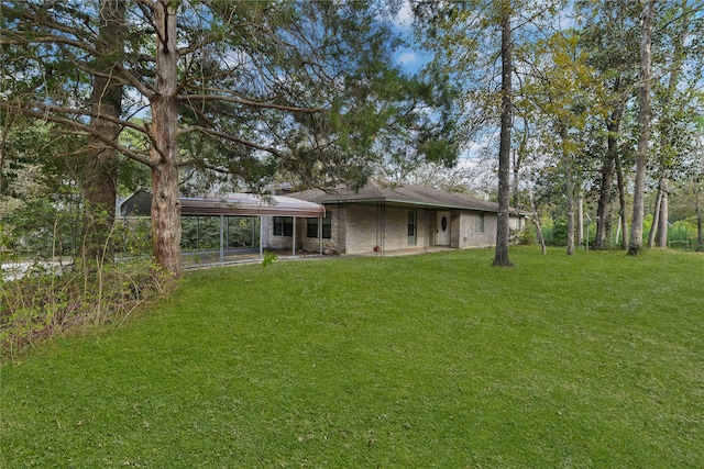 back of house featuring a lawn