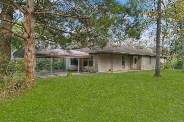 rear view of house featuring a lawn