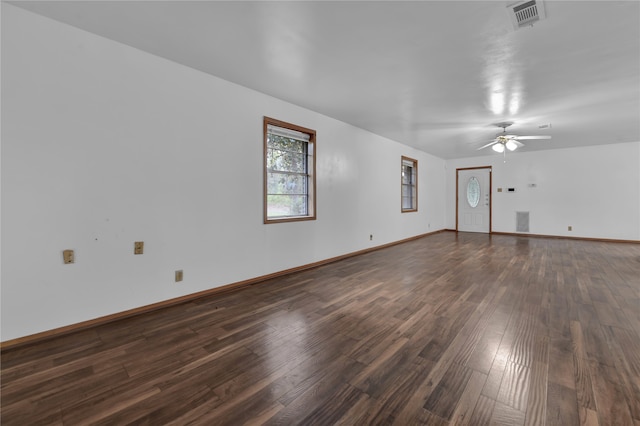 unfurnished living room with ceiling fan and dark wood-type flooring