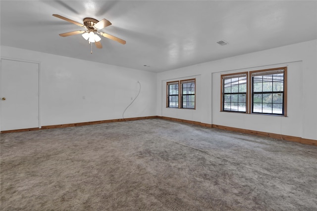 carpeted spare room featuring ceiling fan