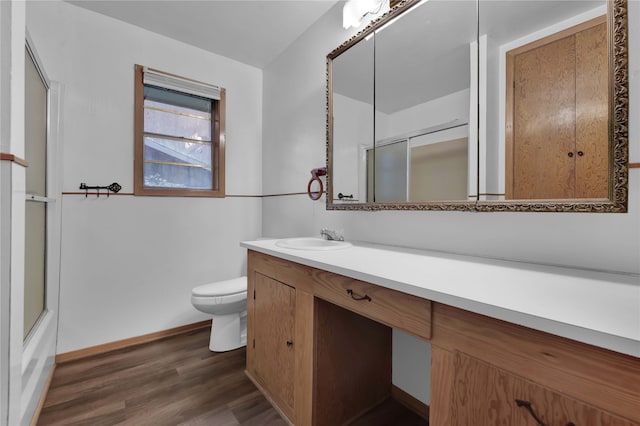 full bathroom featuring vanity, shower / bath combination with glass door, hardwood / wood-style flooring, and toilet