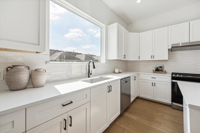 kitchen with white cabinets, stainless steel appliances, backsplash, and sink