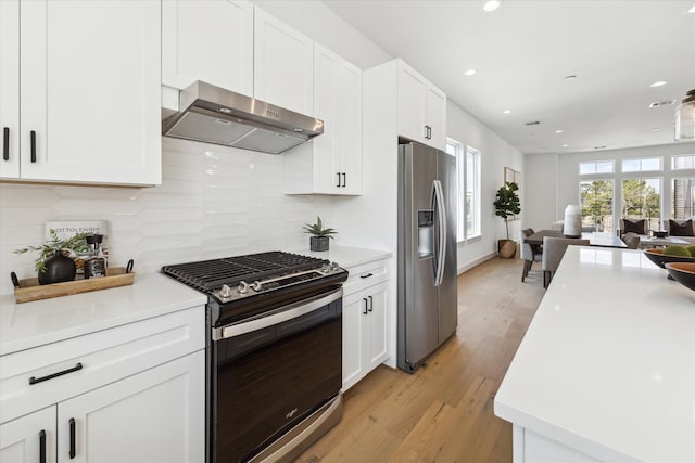 kitchen featuring range hood, white cabinetry, light hardwood / wood-style flooring, stainless steel appliances, and backsplash