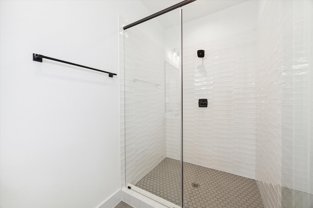 bathroom featuring a shower with shower door