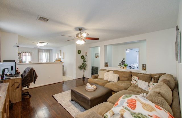 living room featuring dark hardwood / wood-style floors and ceiling fan