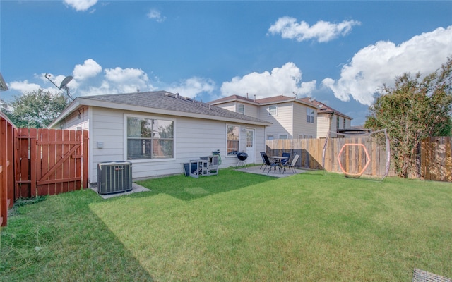 rear view of property with central AC unit, a lawn, and a patio