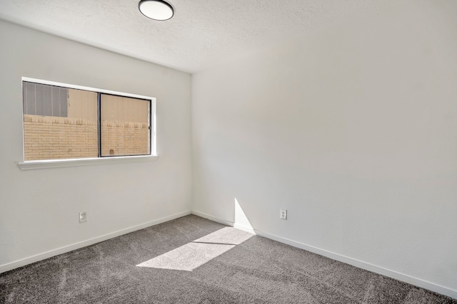 carpeted spare room featuring a textured ceiling