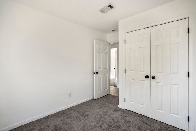 unfurnished bedroom featuring a closet and carpet