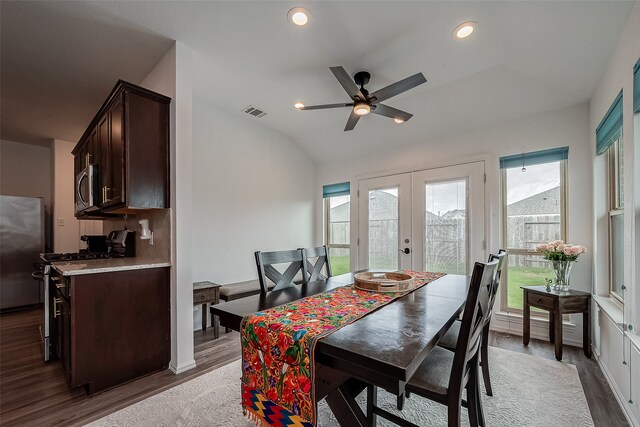 dining space featuring french doors, vaulted ceiling, dark hardwood / wood-style flooring, and ceiling fan