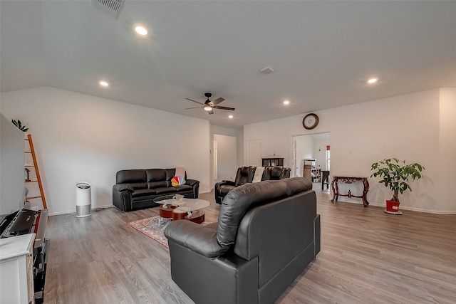 living room featuring ceiling fan and light hardwood / wood-style floors