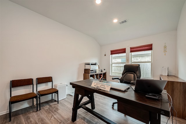 office featuring vaulted ceiling and hardwood / wood-style flooring