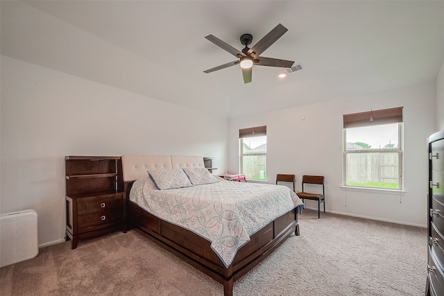 bedroom with ceiling fan and light carpet