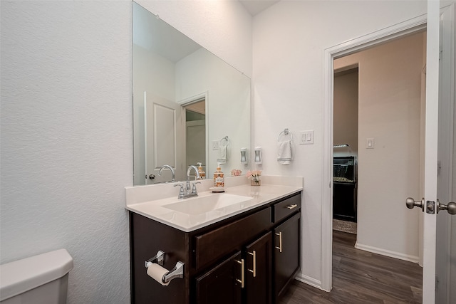 bathroom featuring vanity, toilet, and wood-type flooring