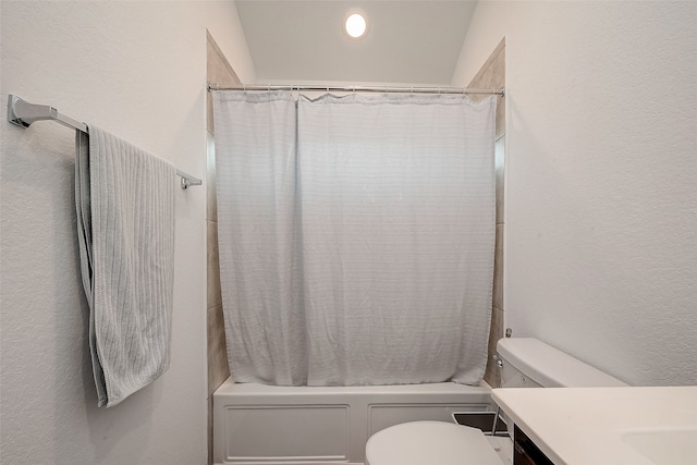 full bathroom with lofted ceiling, vanity, shower / tub combo, and toilet