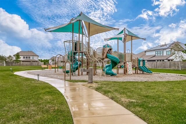 view of playground with a lawn