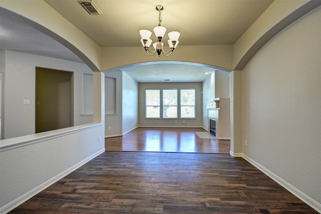 interior space with an inviting chandelier and dark hardwood / wood-style flooring