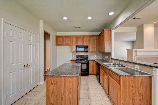 kitchen featuring light tile patterned flooring, sink, tasteful backsplash, black appliances, and dark stone counters