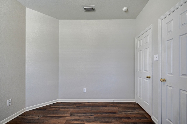 spare room with dark hardwood / wood-style flooring