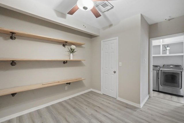 laundry room featuring light wood-type flooring, ceiling fan, and separate washer and dryer