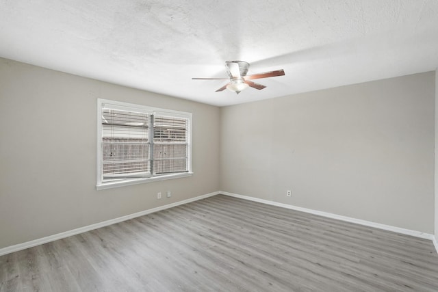 spare room with wood-type flooring and ceiling fan