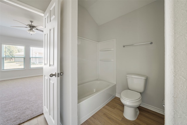 bathroom featuring wood-type flooring, shower / bathtub combination, vaulted ceiling, ceiling fan, and toilet