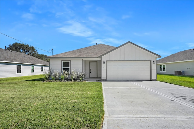 ranch-style home with a garage, a front lawn, and central AC